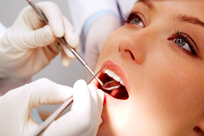 dentista cura denti a donna